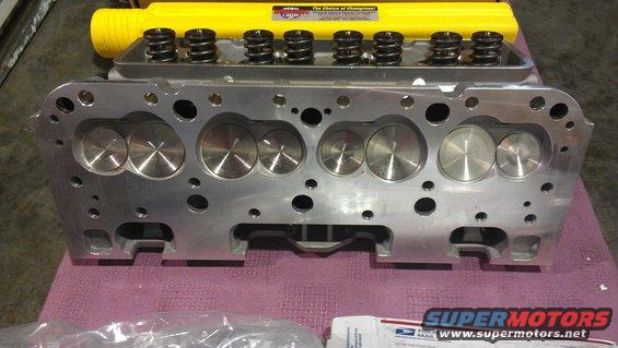 Aluminum engine cylinder head with eight valve springs and a yellow cover