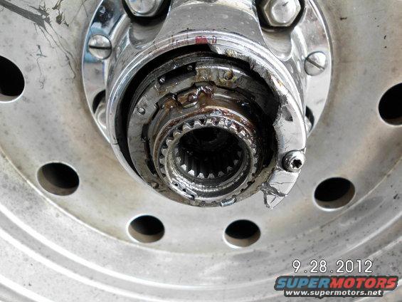 Close-up of a damaged wheel hub assembly with visible splines and metal fatigue