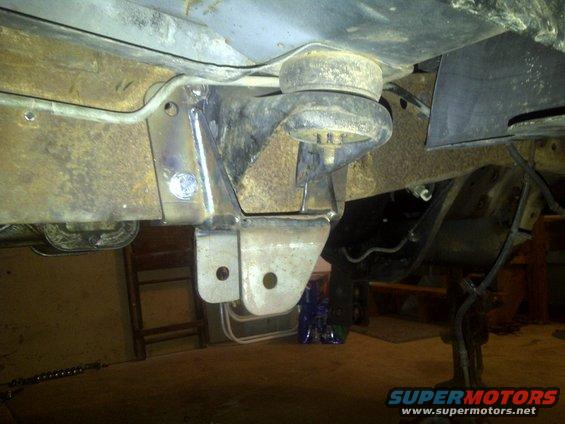 Close-up of vehicle's undercarriage showing suspension mounts and frame