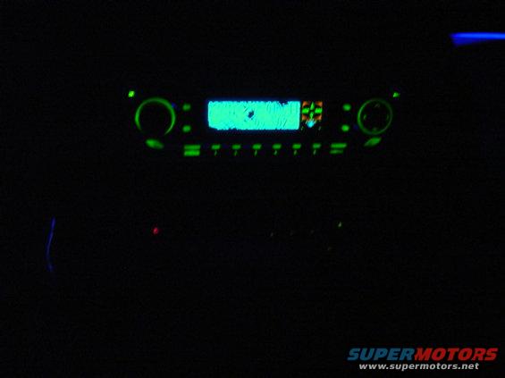 car stereo with glowing green display and buttons