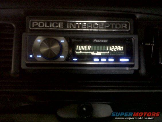 Police Interceptor badge above Pioneer car stereo with tuner display