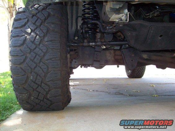 1993 Ford F-150 front suspension with large off-road tires and lifted chassis
