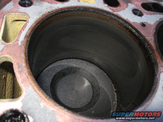 There pistons are the originals (no oversize stamp on them).  Also, there's no ridge at all at the top of any of the cylinders, so it doesn't look like there's a lot of wear on the engine.