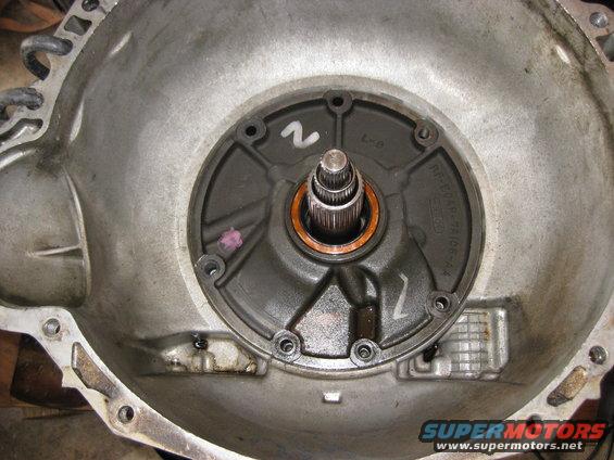 With the bolts removed there are two holes which are threaded into the pump body. In this picture they are at about the 1 o clock and 9 o clock positions. The pump bolts are too small but some other bolts that were removed from the truck fit. A slide hammer can be connected to the bolts to pull the pump out.