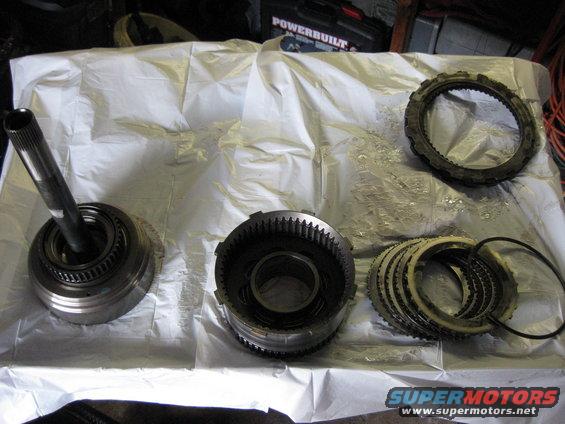 img_0560.jpg From left to Right;
Forward clutch
Reverse clutch drum
Reverse clutches
Top Right: Intermediate clutches

The reverse clutches and intermediate clutches look good and aren't burnt.

