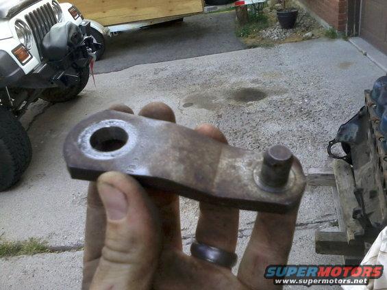 The hydraulic clutch had a splined end that goes through the hole on the clutch arm.  The splined end allows the clutch arm to go on in any direction, allowing for adjustment should it be needed while lining it up with the master cylinder arm.

I later found out that you CANNOT reuse these clutch arms.  The splines are cut into them when they're tightened down on the rod and are weakened when removed.  I tried to reuse it and when I pushed on the clutch, it twisted through the splines on the arm like butter, making it smooth inside.

Either buy a new one (not easy to find and around $50) or REMOVE THE CLUTCH ROD AND ARM IN ONE PIECE.  Unbolt the entire pedal assembly from under the dash and turn it to the side so you can slide the rod and arm out together.  Put it back in the same way.  It may seem like a bit more work, but it's not that hard, and well worth it!
