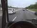 2003 Ford Crown Victoria - A white minivan is stopped on the highway with its doors open, while other vehicles pass by.