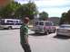 2003 Ford Crown Victoria - Multiple vehicles are parked in a lot outside a building labeled 'EAGLE HANGAR'.