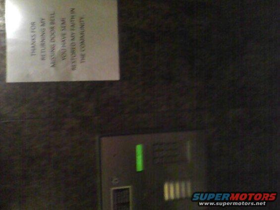 Doorbell panel with a green light and a note that reads 'THANKS FOR RETURNING MY MISSING DOOR BELL YOU HAVE SEMI RESTORED MY FAITH IN THE COMMUNITY.'