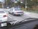 2003 Ford Crown Victoria - A silver Lincoln Town Car is seen from another vehicle's perspective on a city street.