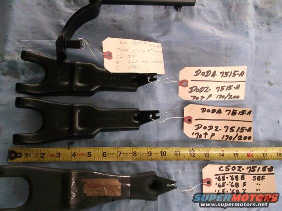 Clutch fork parts with part numbers and ruler for scale
