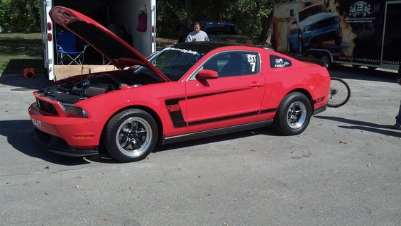 Red 2007 Ford Mustang Boss 302 with racing stripes and number 7 decal, hood open