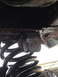 1996 Ford F-150 - This image shows a close-up of a suspension component, likely a block, mounted on a coil spring assembly.