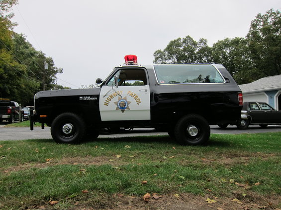 1987 Dodge Ramcharger Highway Patrol SUV parked on grass, with another car in the background