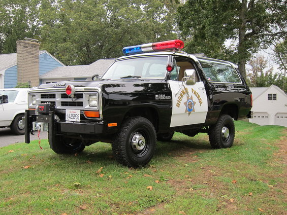 Black and white Dodge Ramcharger with light bar and "Highway Patrol" markings