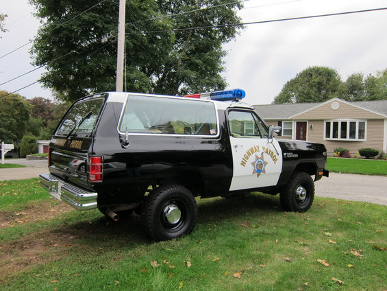 Black and white Dodge Ramcharger police vehicle with "Highway Patrol" text and light bar