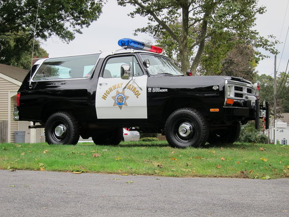 Black and white Dodge Ramcharger police SUV with "HIGHWAY PATROL" text and badge