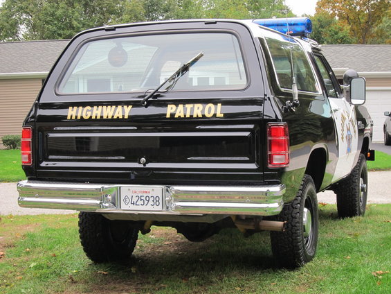 Black Dodge Ramcharger with "HIGHWAY PATROL" text, rear view