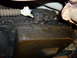 1997 Ford Crown Victoria - Underside view of a heavily greased transmission pan and associated linkage.