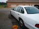 1997 Ford Crown Victoria - White 1997 Ford Crown Victoria parked outside a brick garage with multiple bays.