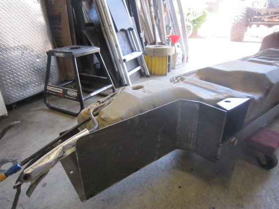 Aftermarket skid plate for a fuel tank, made of metal with welded brackets