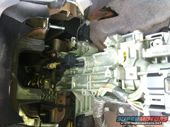 Close-up of car's steering column ignition switch and shifter linkage