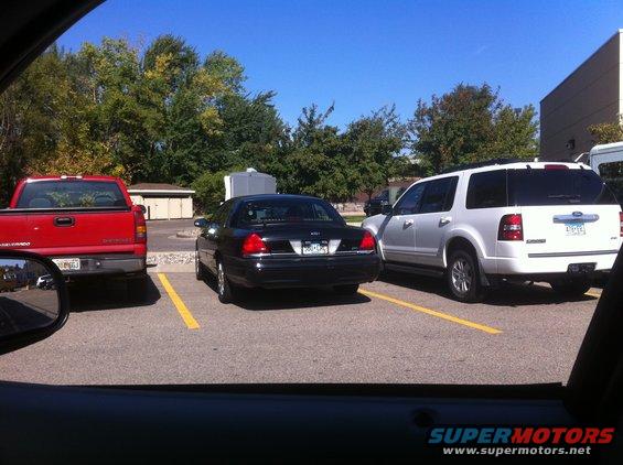 Black 2003 Ford Crown Victoria parked in a lot, rear view