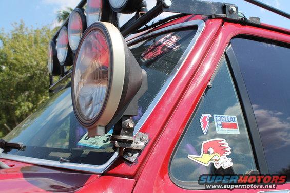 Red SUV's A-pillar light and windshield stickers