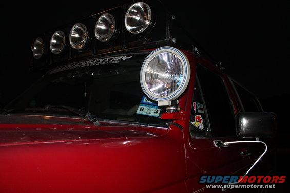 Red 1990 Ford Bronco with roof lights and a pillar light
