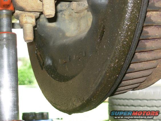 It's gear oil from the inner wheel seal slinging to the inside of the drum, wetting the brake shoes, and working past them to the backing plate.