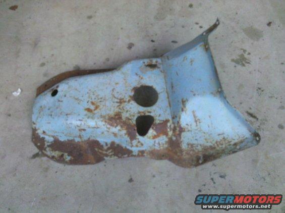 Rusted light blue metal auto part with two circular cutouts and one triangular cutout