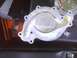 2003 Ford Crown Victoria - A close-up view of a water pump, showing its internal impeller and external mounting points.
