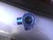 2003 Ford Crown Victoria - A blue thermostat housing is shown, likely a replacement part for a vehicle.