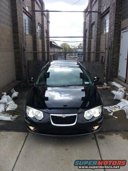 Front view of a black 2002 Chrysler 300M parked in an alleyway