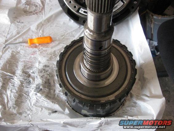 img_0640.jpg The output shaft is carefully placed into the direct clutch drum and drive shell and a snap ring holds the output shaft to the drive shell.