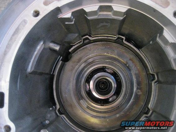In this picture the anit-clunk spring can be seen in the upper right between the case and planetary gearset. It is installed with the tabs pointing up.