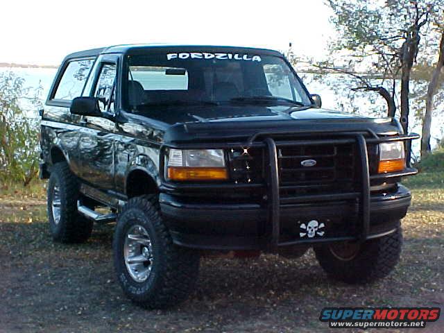 Black Ford Bronco with bull bar and skull decal, parked outdoors