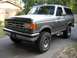 1988 Ford Bronco - This two-tone Ford Bronco is shown from a three-quarter front angle, parked in front of a house.