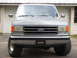 1988 Ford Bronco - This Ford Bronco is seen from the front, parked in front of a garage door.