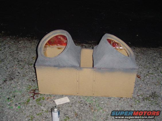Custom speaker box with two large circular openings, made of particle board and gray material
