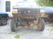 1982 Ford Bronco - Front end of a Ford truck, likely from the 1990s, with its bumper removed and suspension visible.