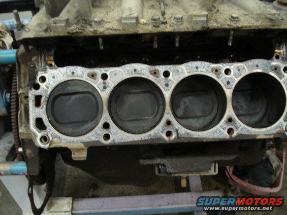 Engine block with pistons visible, part of a rebuild
