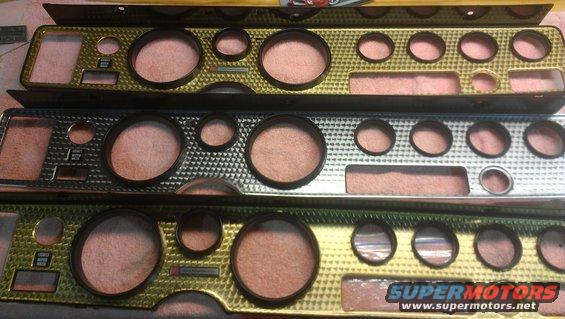 Three car dashboard gauge clusters with gold and silver trim. One cluster has a black trim