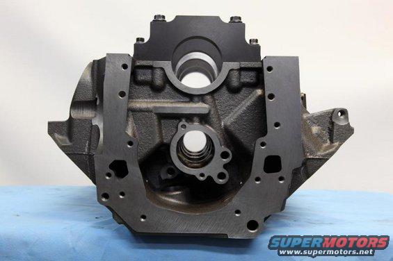 Black cast iron engine block with metal plates bolted to the top and sides