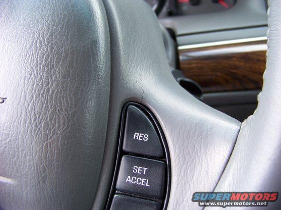 Close-up of a cracked steering wheel with cruise control buttons labeled RES and SET ACCEL