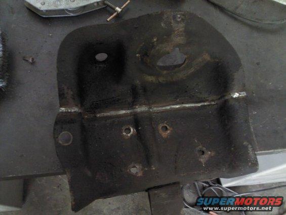 Welded metal bracket with multiple holes and signs of repair