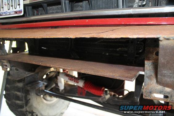 Custom steel plate bumper and red Rough Country shock absorber