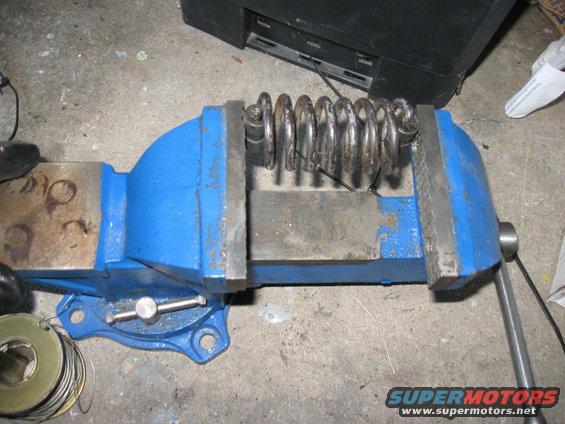 Once the pedals and rod are in, the clutch spring needs to be put back in.  Unless you're The Hulk, there's no way you're going to get the spring in with your bare hands.  

I compressed it in a vice and wired it down.