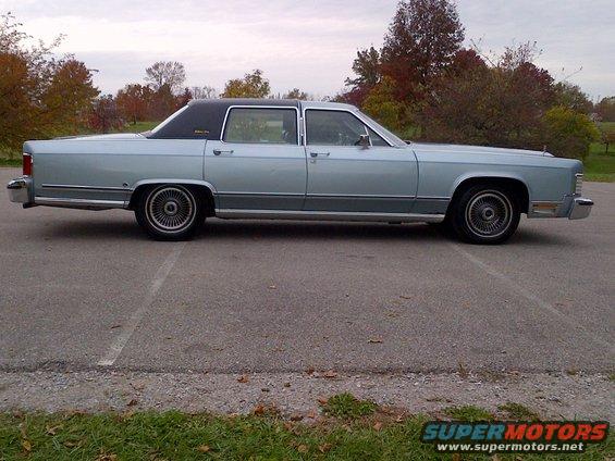 Light blue 1970s Lincoln Continental sedan with a black vinyl roof, seen from the side