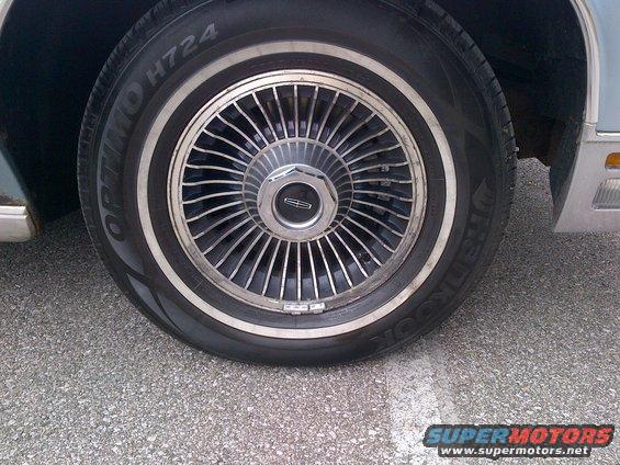 Close-up of a Lincoln wheel with a chrome hubcap and whitewall tire
